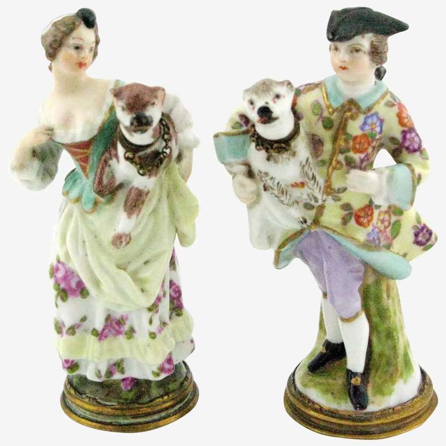 A pair of antique figural porcelain scent bottles of a couple and dogs