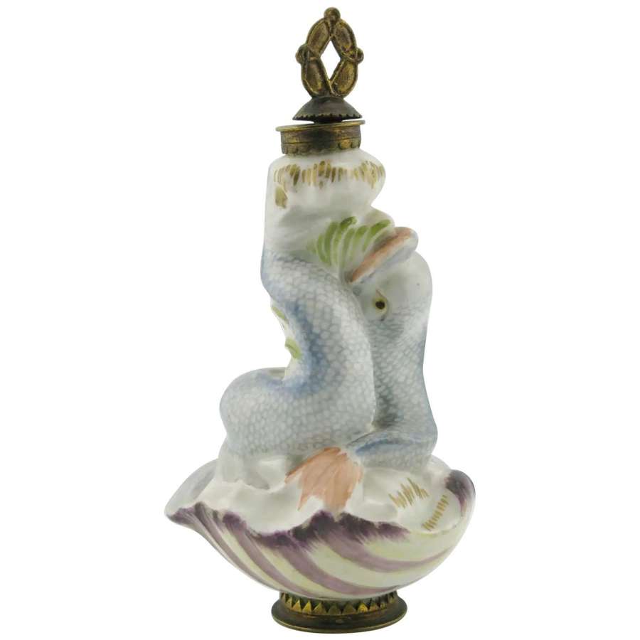 An antique porcelain scent bottle 2 dolphins on shell.